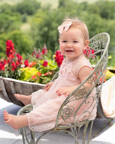 smiling baby on iron chair