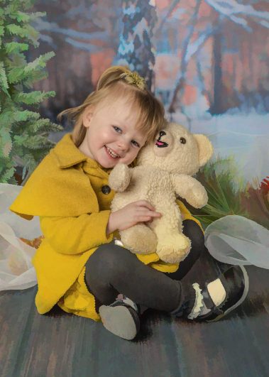 girl hugging teddy bear